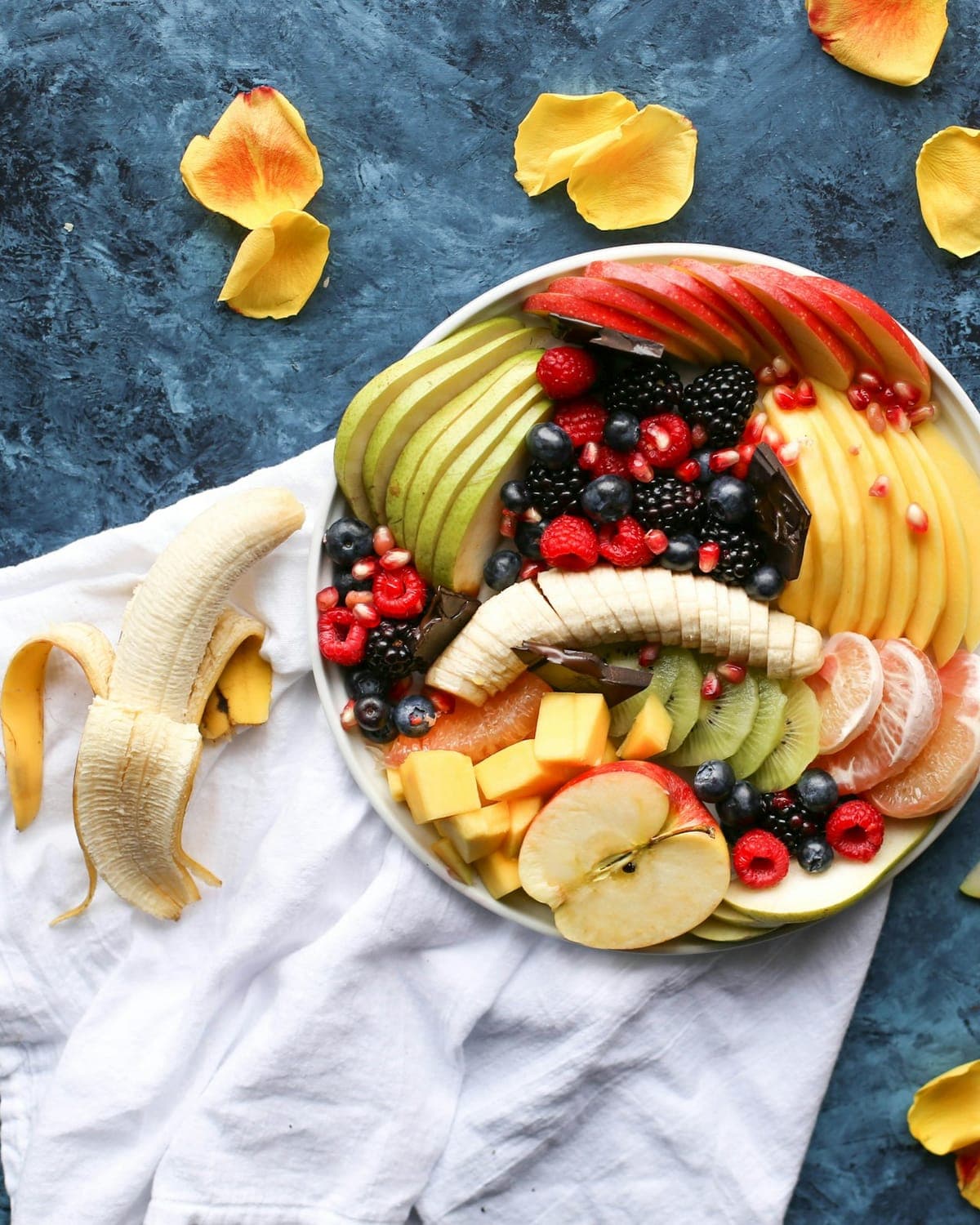 Villa kitchen counter stocked before arrival — market fruit, Blue Mountain coffee, cut flowers, a handwritten note propped against the bowl