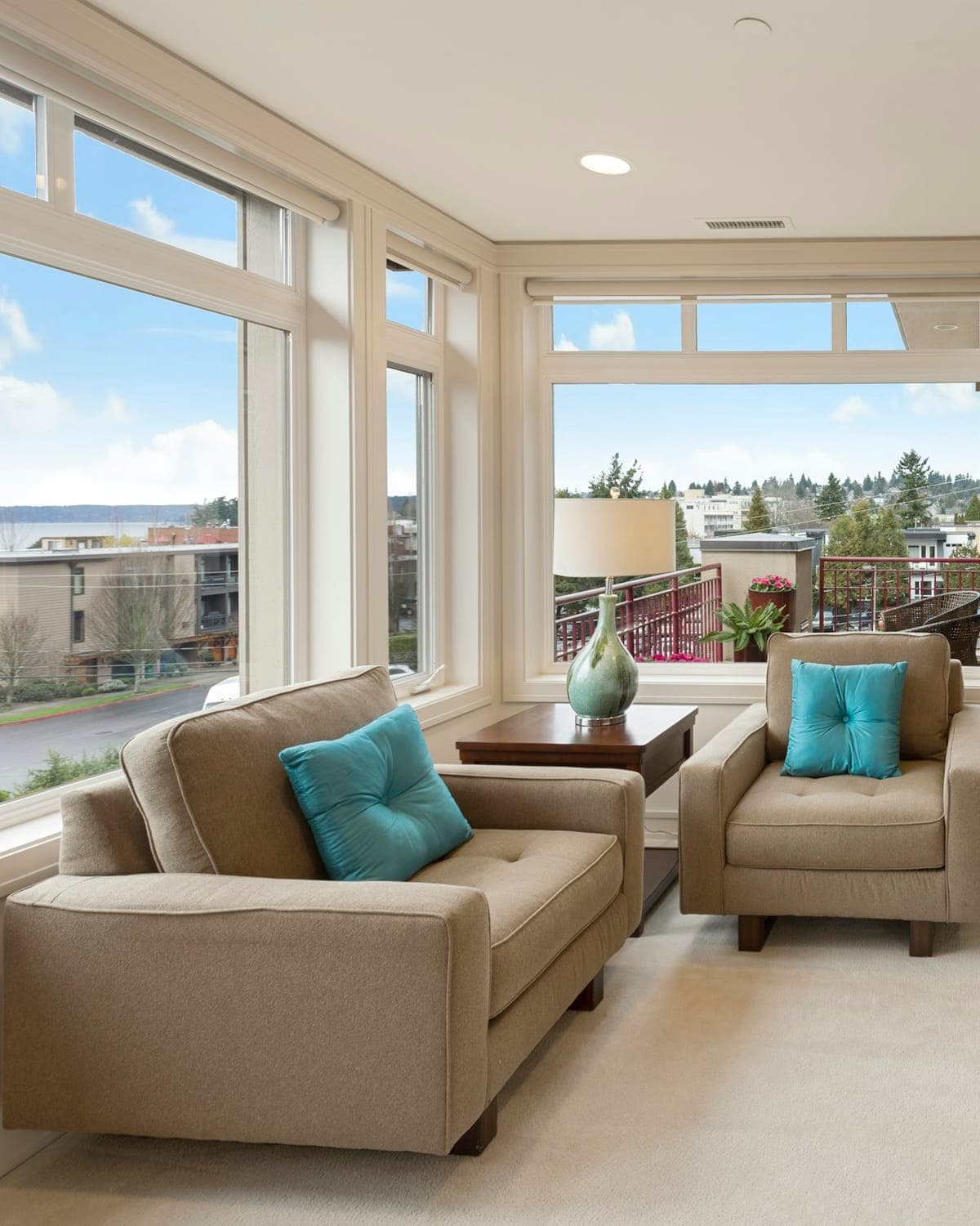 Bright living room open to the sea — linen sofa, breeze in the curtains