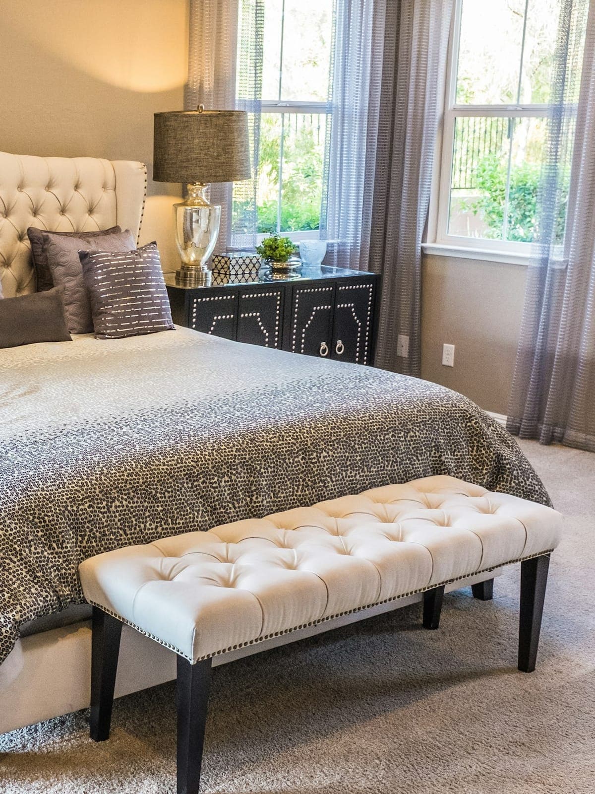 Primary suite — white linen, louvered doors open to the veranda