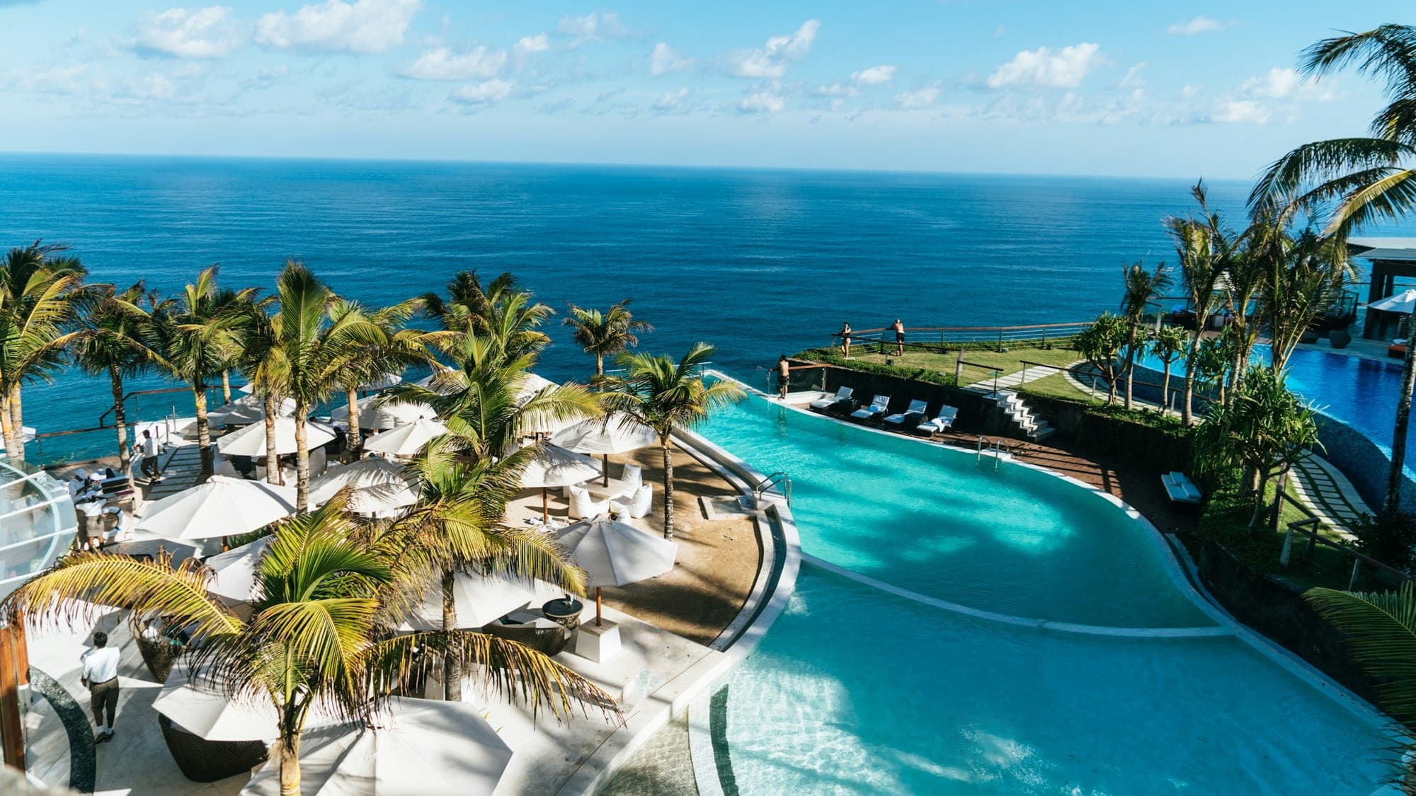 Blue Mahoe House on the cliff edge — garden, terrace, open sea beyond